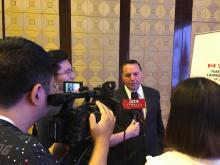 Wally Schumann speaks with media in China