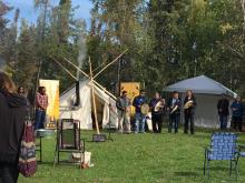 Drummers playing at urban hide tanning camp Yellowknife